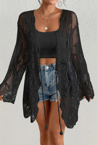 Woman wearing a black open front lace kimono cardigan.