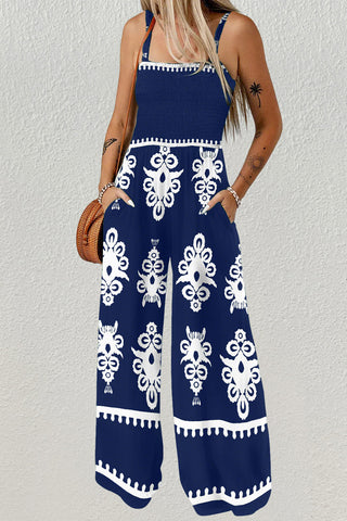 A woman wearing a blue sleeveless wide Leg Romper with Pockets.