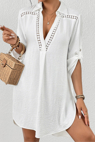 A woman wearing a V-neck bathing suit cove up for swimwear.