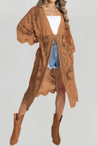 A woman wearing a brown kimono summer cardigan.