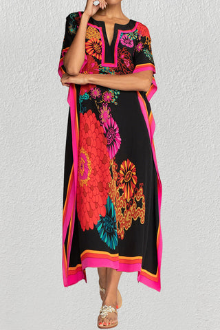 A woman wearing a floal summer maxi kaftan dress.