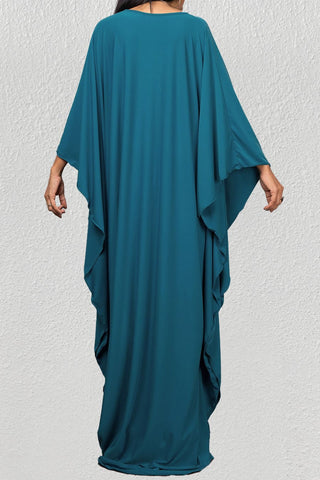 A woman wearing a pool caftan cover up womens.