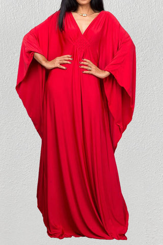A woman wearing a red beach kaftan dress maxi.
