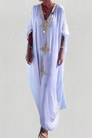 A woman wearing a v-neck womens kaftan cover up.