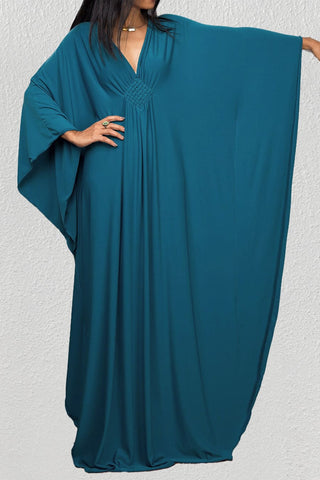 A woman wearing a vacation beach kaftan dresses.