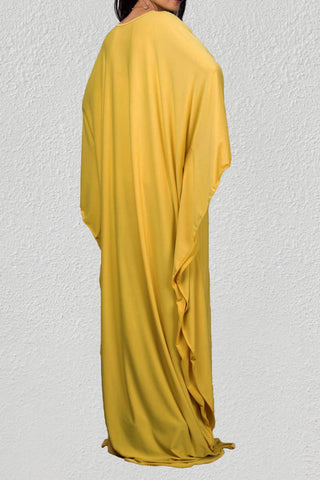A woman wearing a yellow plus size beach  kaftan dresses.