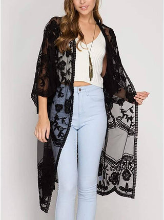 A woman wearing a kimono
 lace black with pants.
