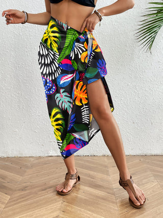 A woman wearing a Boho Sarong Coverup Rosy Floral with bikini.