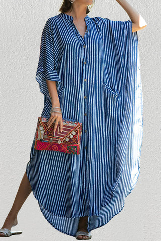 A woman wearing a casual maxi caftan dress with sun-glasses.