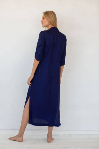 A woman wearing a long beautiful kaftan dress.