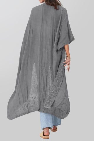 A women wearing a sheer maxi kimono cover up.