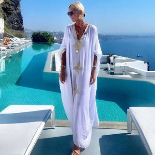 A woman wearing a v-neck womens kaftan cover up.
