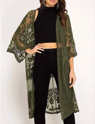 A woman wearing a green lace kimono cardigan outfit.