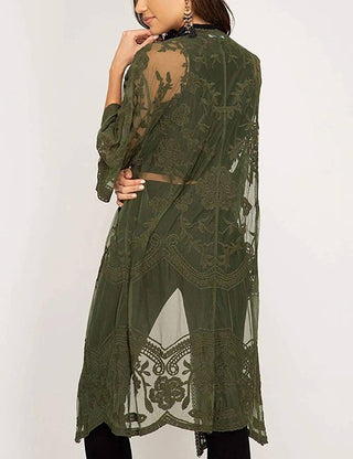 A woman wearing a green lace summer kimono cardigan outfit.